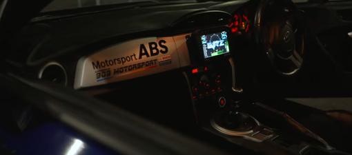 Subaru BRZ interior at night with Bosch Motorsport ABS display and 909 Motorsport dash banner at Sydney Motorsport Park