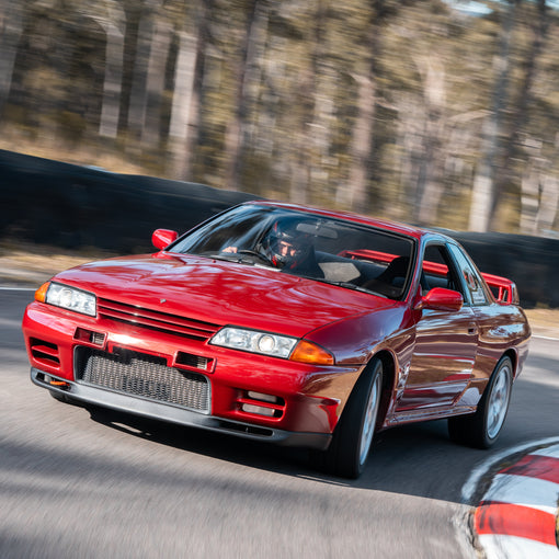 Red Nissan Skyline GT-R braking on circuit running 909 Motorsport Bosch M5 ABS