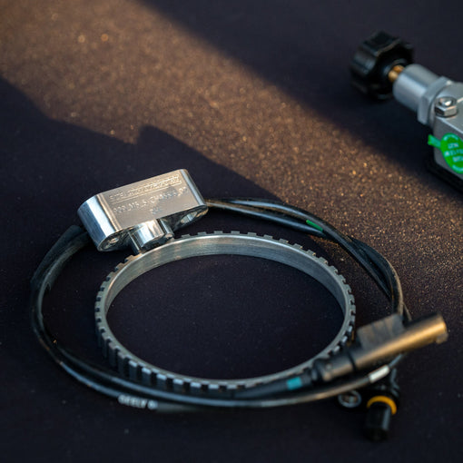 Bosch Motorsport DF11 wheel-speed sensor with toothed trigger ring and 909 Motorsport CNC-machined mounting bracket