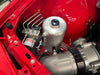 Bosch Motorsport ABS M5 hydraulic unit plumbed with brake hardlines beside an alloy reservoir in a red engine bay