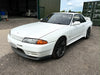 Supertec Racing's white Nissan Skyline R32 GT-R outside their UK workshop
