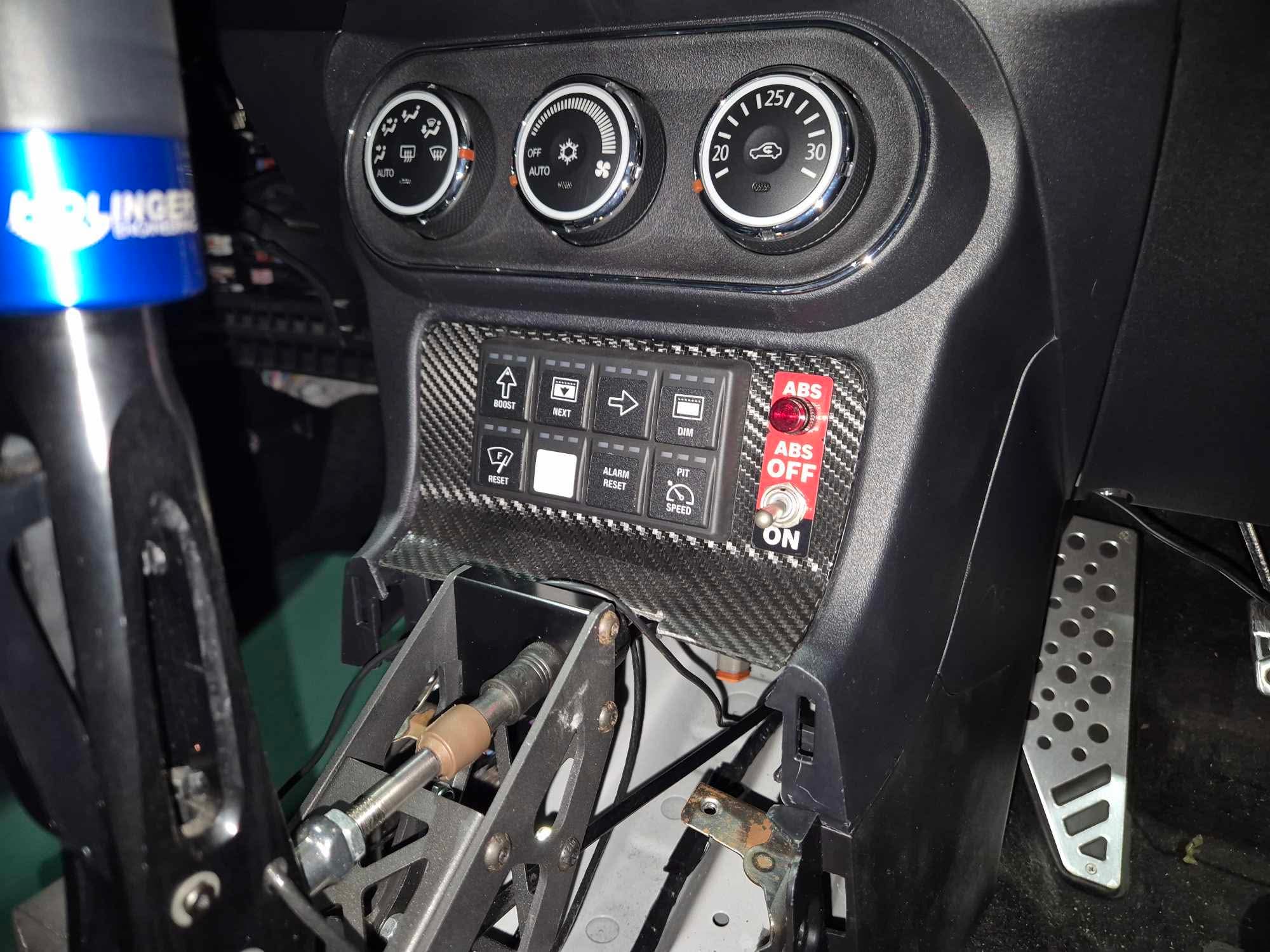 Mitsubishi Lancer EVO X cabin showing the Bosch ABS map switch and ABS-off switch panel