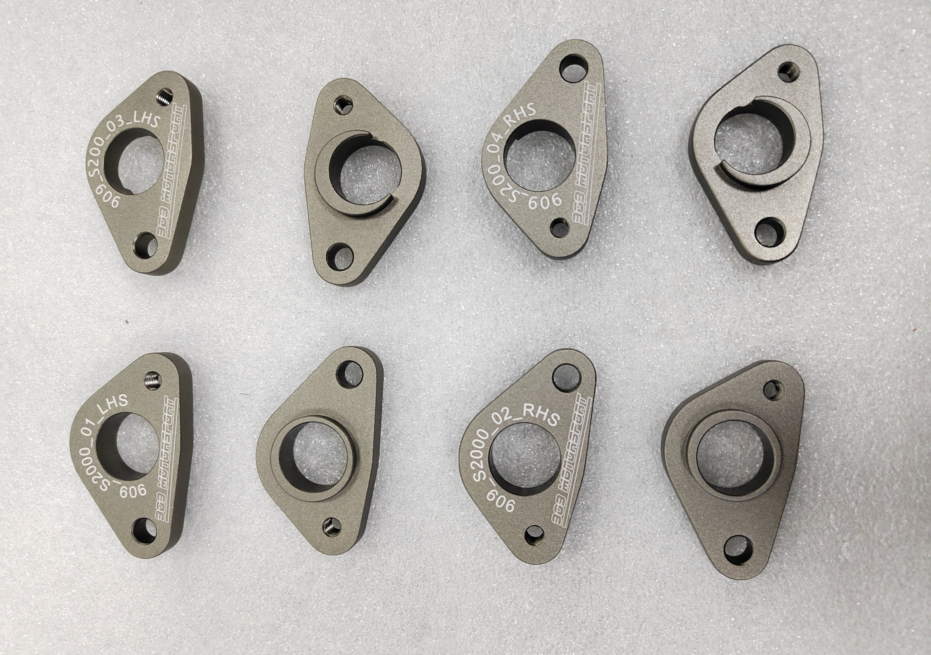 909 Motorsport wheel speed sensor mounts for the Honda S2000 - handed left and right, machined and anodised, shown front and back