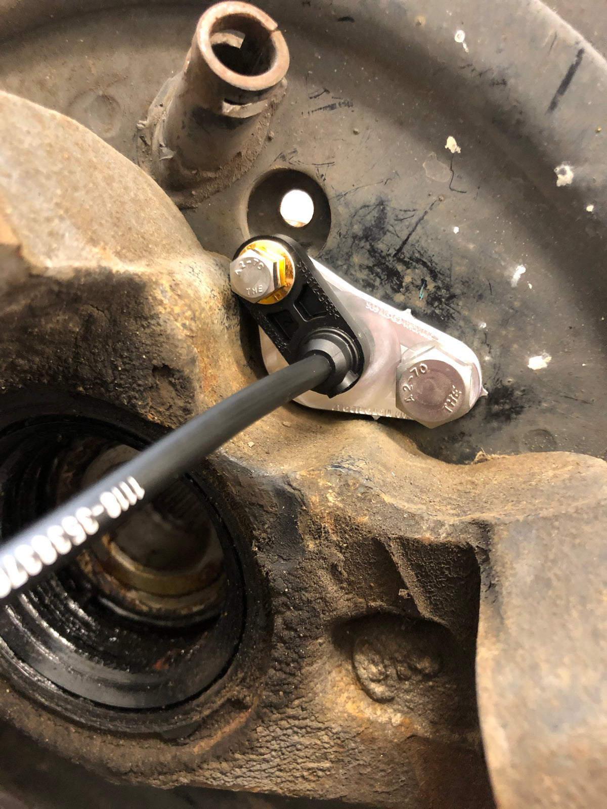 909 machined wheel speed sensor mount installed on the Subaru WRX GD with Bosch DF11 sensor