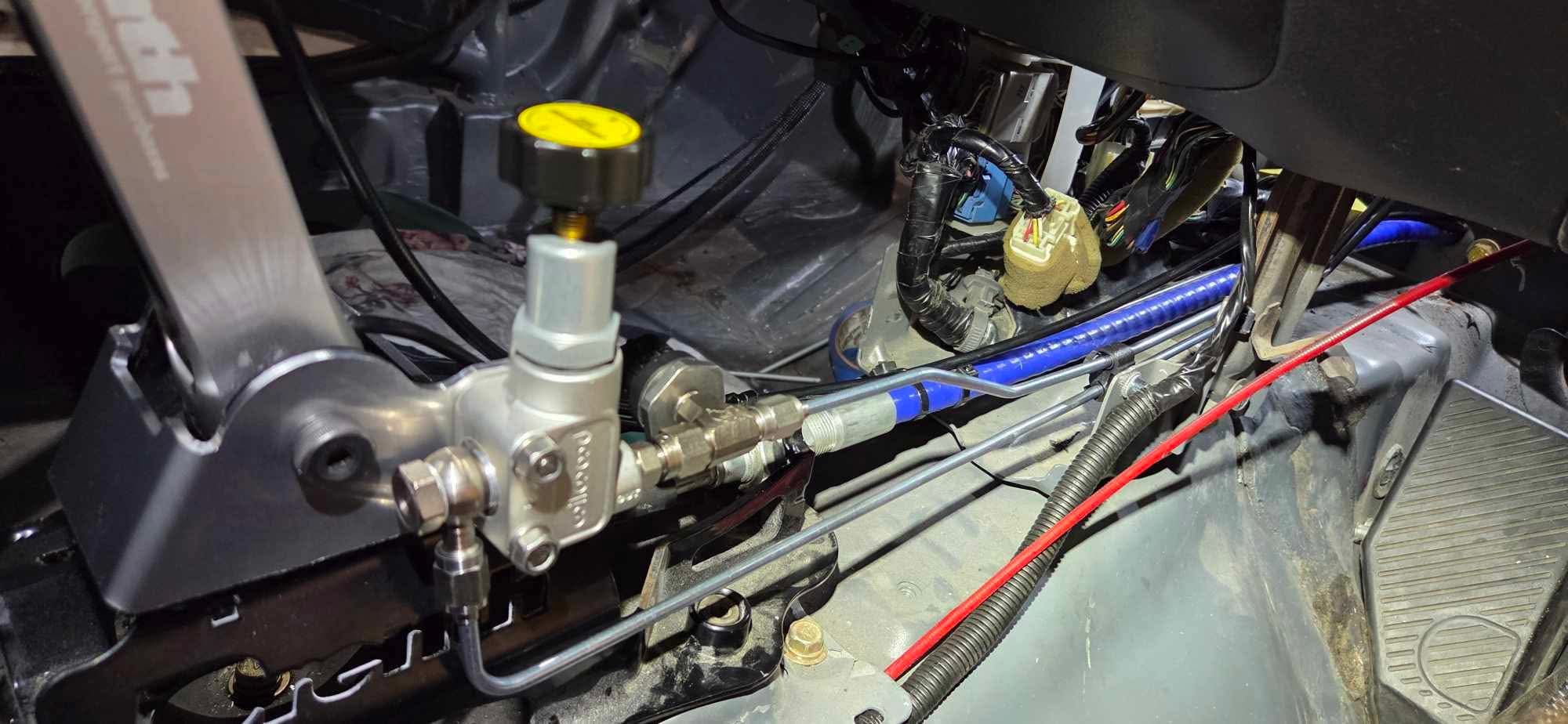 Under-bonnet brake bias valve installation on a Mitsubishi Lancer EVO 7-9