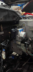Bosch Motorsport M5 ABS hydraulic unit installed in the engine bay of a Mitsubishi Lancer EVO 7-9