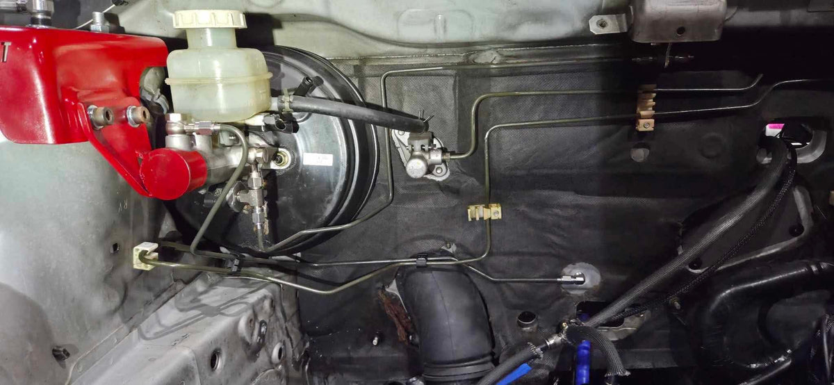 Master cylinder and brake lines in the engine bay of a Mitsubishi Lancer EVO 7-9 fitted with the 909 Bosch Motorsport M5 ABS kit