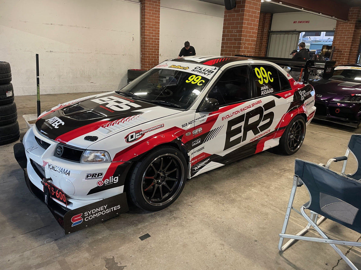 Evolution Racing Spares Mitsubishi Lancer EVO 6 in the pit garage, 909 Motorsport and Bosch decals on the windscreen — Bosch Motorsport M5 ABS equipped
