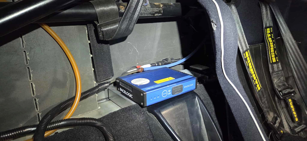 Racelogic VBOX recorder mounted in the Lotus Exige — the 909 parcel-shelf yaw sensor mount is offered with VBOX provision