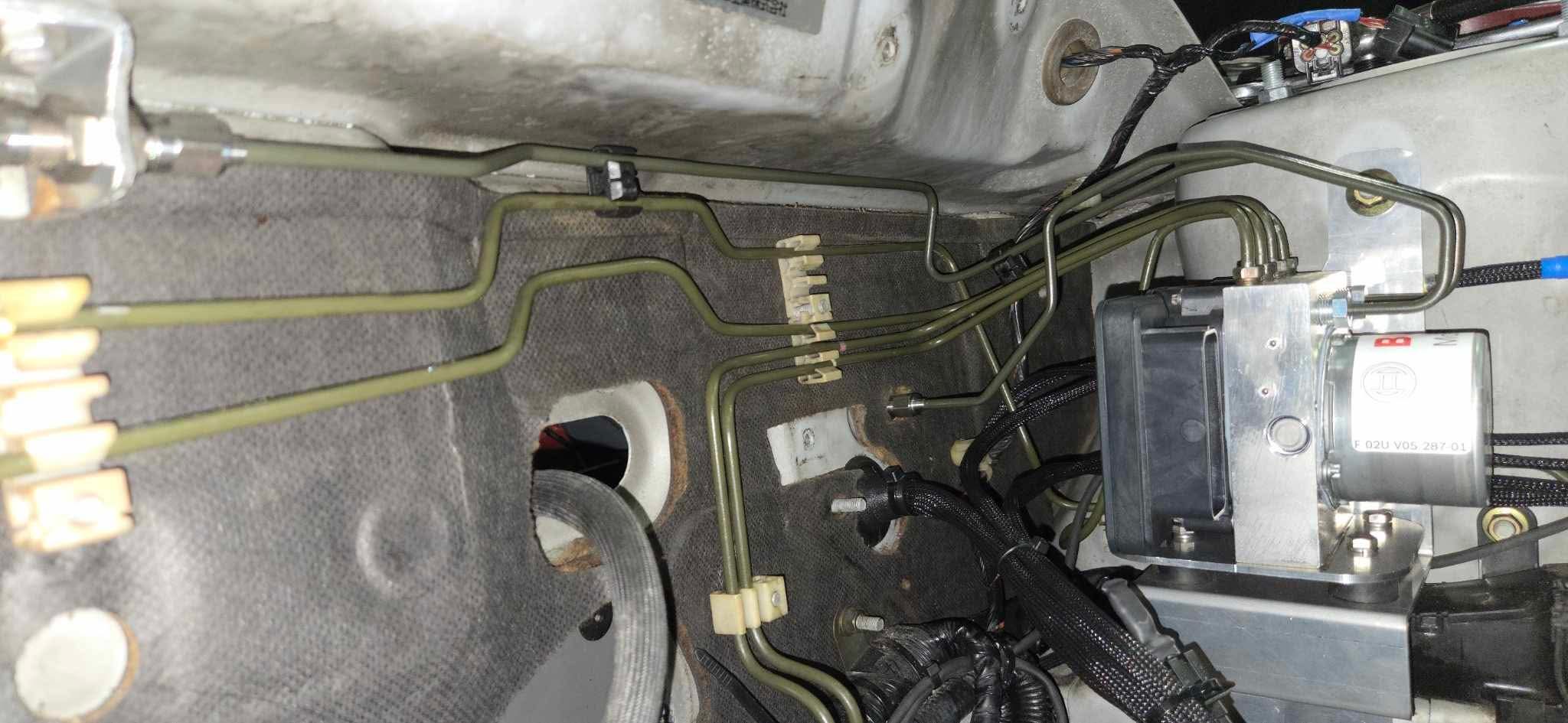 Brake hard lines routed to the Bosch Motorsport M5 ABS hydraulic unit on a Mitsubishi Lancer EVO 7-9