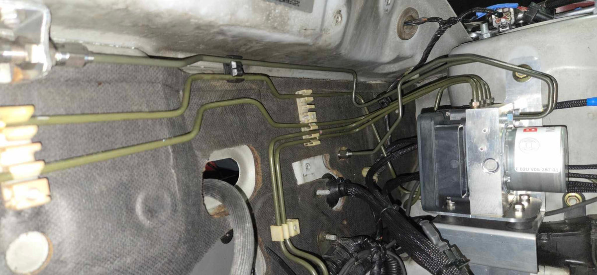 Brake hard lines routed to the Bosch Motorsport M5 ABS hydraulic unit on a Mitsubishi Lancer EVO 7-9