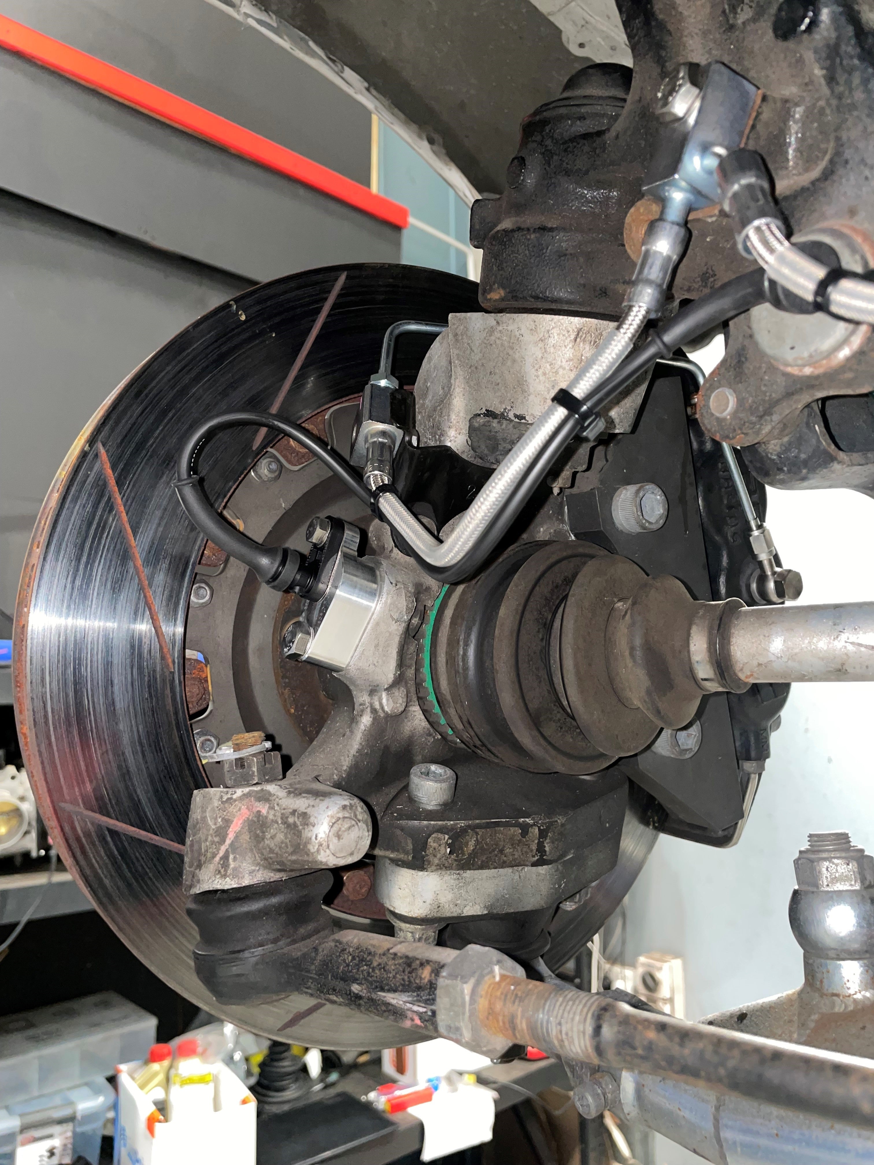 Front wheel speed sensor mount with Bosch DF11 sensor installed on a Nissan Skyline GT-R hub